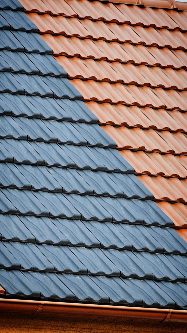 Close-up of roof tiles with striking blue and orange pattern.